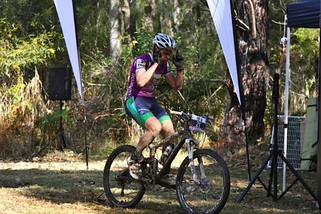 An exhausted Matt Fleming can barely lift his arms as he wins on a very tough day out