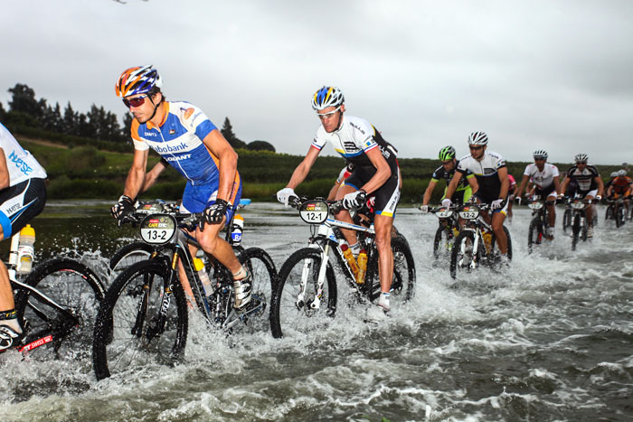 Riders forge their way through a creek early on stage 2. Photo: Sportograf