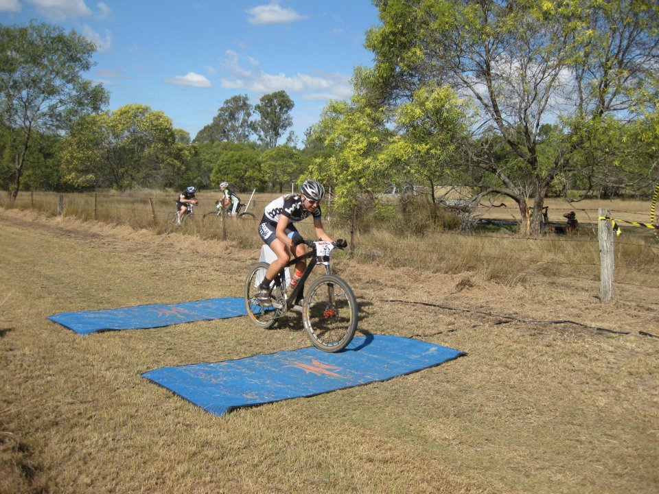 Imogen Smith, racing in typical Queensland conditions - plus the timing mats double up as a post race slip'n'slide! Photo: Marianne Westacott